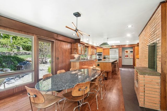 71 Boulderol Rd, Stamford, CT 06903 - dining area with dark wood-type flooring, a ceiling fan, wooden walls, and recessed lighting