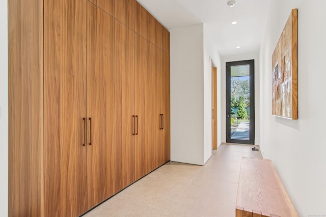 hallway with light floors and recessed lighting