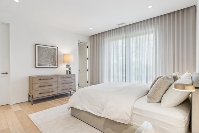bedroom featuring light wood finished floors and recessed lighting