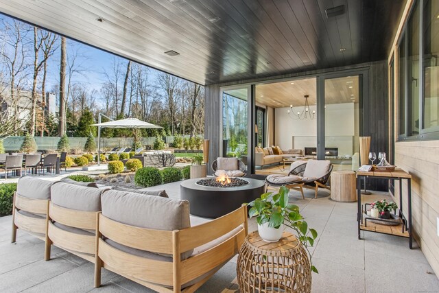sunroom / solarium with a chandelier