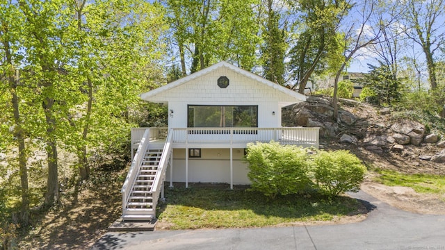view of front of property featuring a deck and stairway