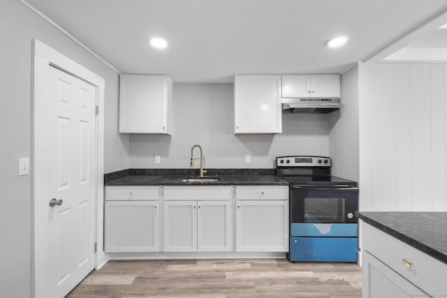 kitchen featuring under cabinet range hood, white cabinets, a sink, and range with electric stovetop