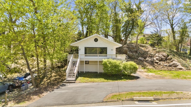 view of front of property featuring stairway