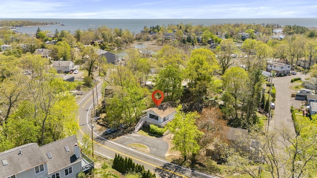 drone / aerial view with a water view and a residential view