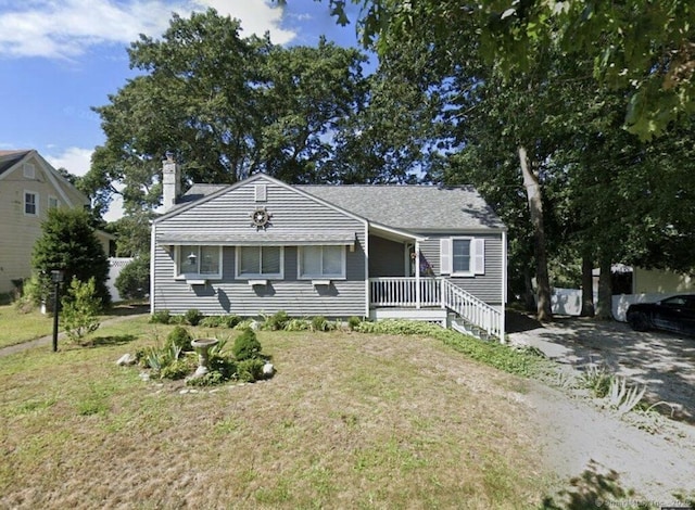 37 Woodland Dr, Old Saybrook, CT 06475 - view of front of property featuring a chimney and a front yard