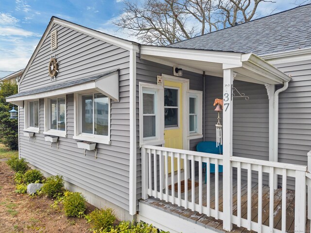 37 Woodland Dr, Old Saybrook, CT 06475 - view of side of home with roof with shingles and a porch