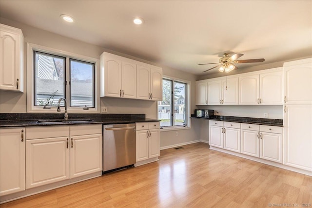 kitchen featuring a sink, white cabinetry, a ceiling fan, and dishwasher