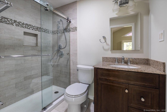 bathroom with vanity, toilet, and a stall shower
