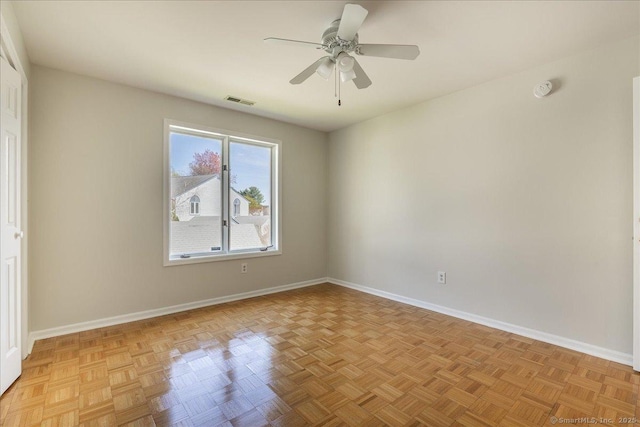 unfurnished room with visible vents, baseboards, and a ceiling fan