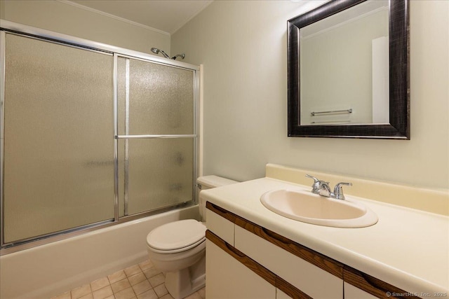 bathroom with toilet, enclosed tub / shower combo, tile patterned flooring, and vanity