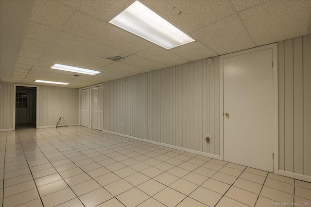 unfurnished room featuring a drop ceiling