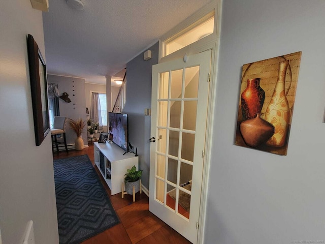 24 Deerwood Ln Unit 3, Waterbury, CT 06704 - corridor featuring a textured ceiling, wood finished floors, and a baseboard heating unit