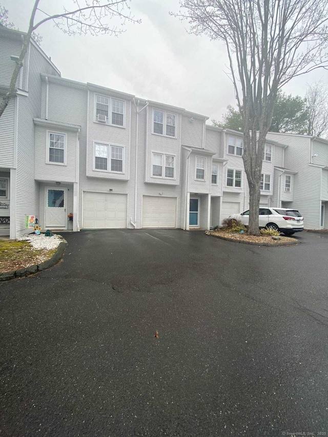 24 Deerwood Ln Unit 3, Waterbury, CT 06704 - townhome / multi-family property with driveway, stucco siding, and a garage