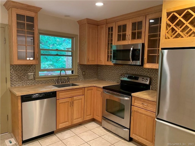 kitchen with light countertops, a sink, and stainless steel appliances