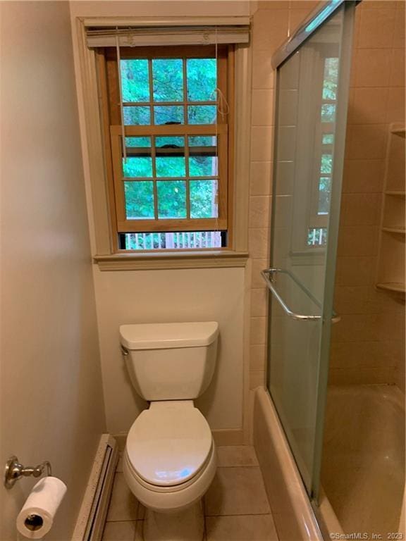 bathroom featuring toilet, a baseboard radiator, baseboards, and tile patterned floors
