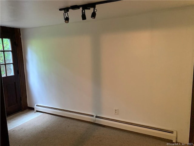 interior space featuring carpet flooring, baseboard heating, and track lighting
