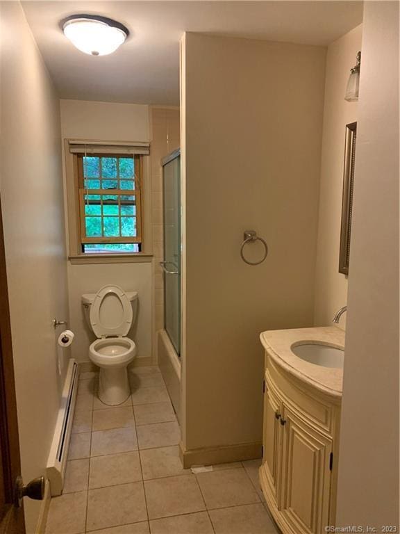 bathroom with vanity, tile patterned flooring, toilet, a baseboard radiator, and baseboards