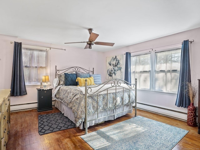 48 Meyer Pl, Greenwich, CT 06878 - bedroom with a baseboard radiator, dark wood-style flooring, a baseboard heating unit, and ceiling fan