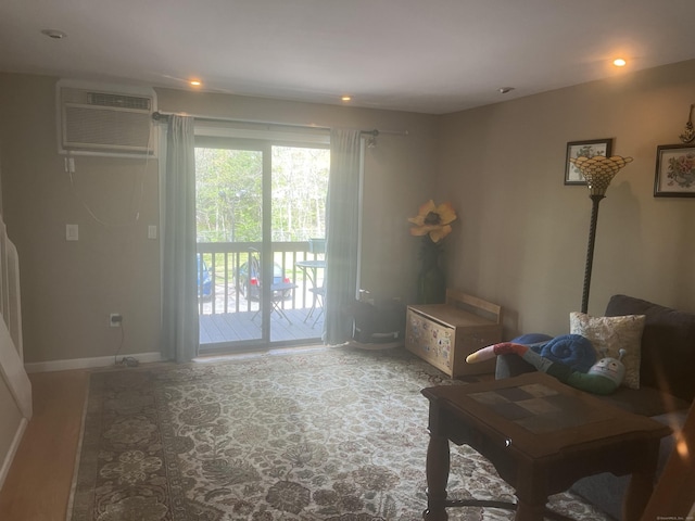 interior space with baseboards, a wall unit AC, and recessed lighting