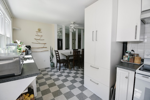 23 Hart Pl Apt 3, Plainville, CT 06062 - kitchen with black refrigerator, white range with electric cooktop, dark floors, a ceiling fan, and white cabinets