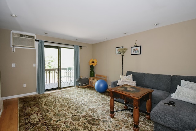 23 Hart Pl Apt 3, Plainville, CT 06062 - living area with a wall unit AC, wood finished floors, and baseboards