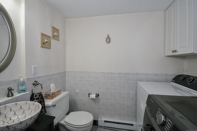 23 Hart Pl Apt 3, Plainville, CT 06062 - half bathroom with baseboard heating, tile walls, toilet, wainscoting, and washer and clothes dryer