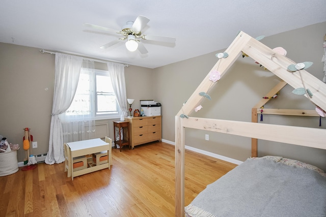 23 Hart Pl Apt 3, Plainville, CT 06062 - bedroom with a baseboard radiator, wood finished floors, a ceiling fan, and baseboards