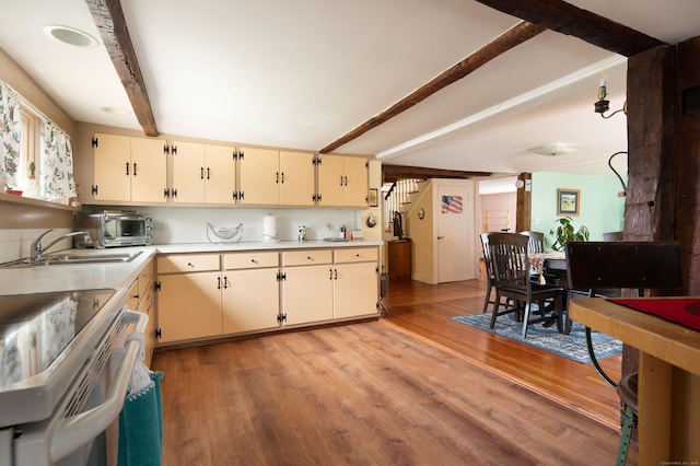 2 Perry St, Salisbury, CT 06039 - kitchen with beam ceiling, electric stove, light countertops, light wood-type flooring, and cream cabinets