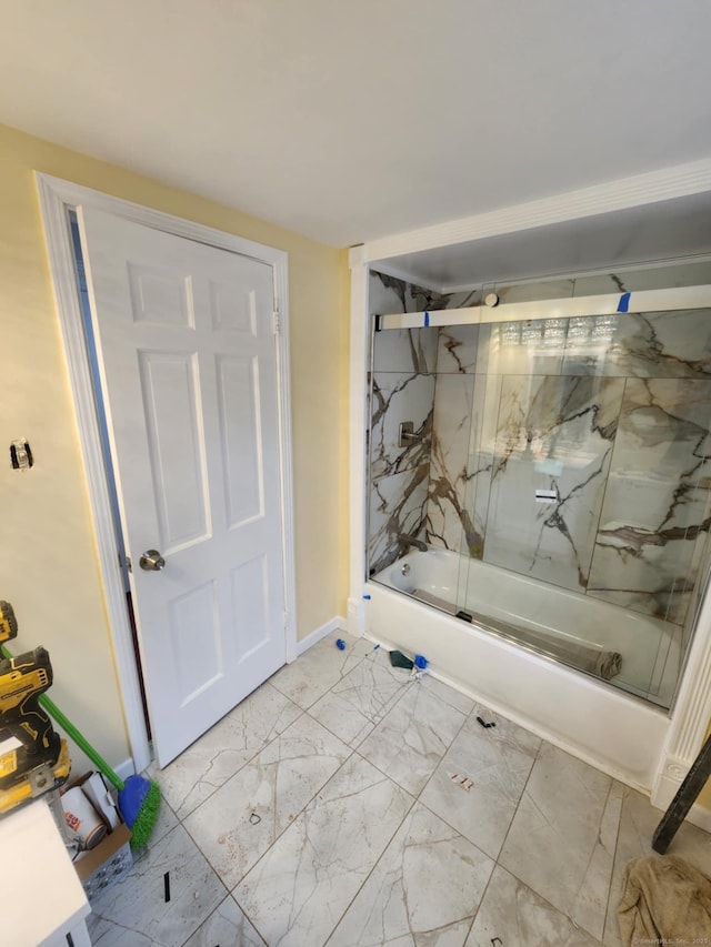 full bathroom featuring baseboards, enclosed tub / shower combo, and marble finish floor