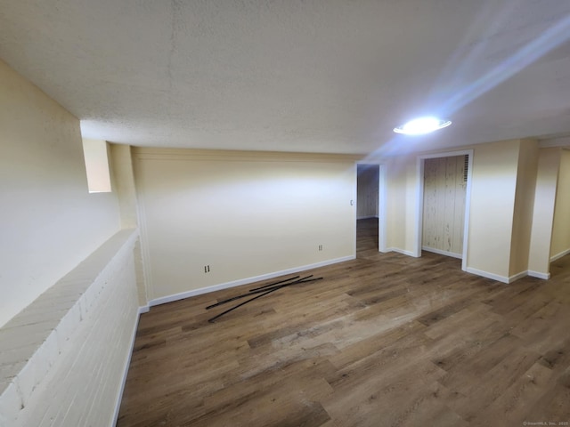finished basement featuring baseboards and wood finished floors