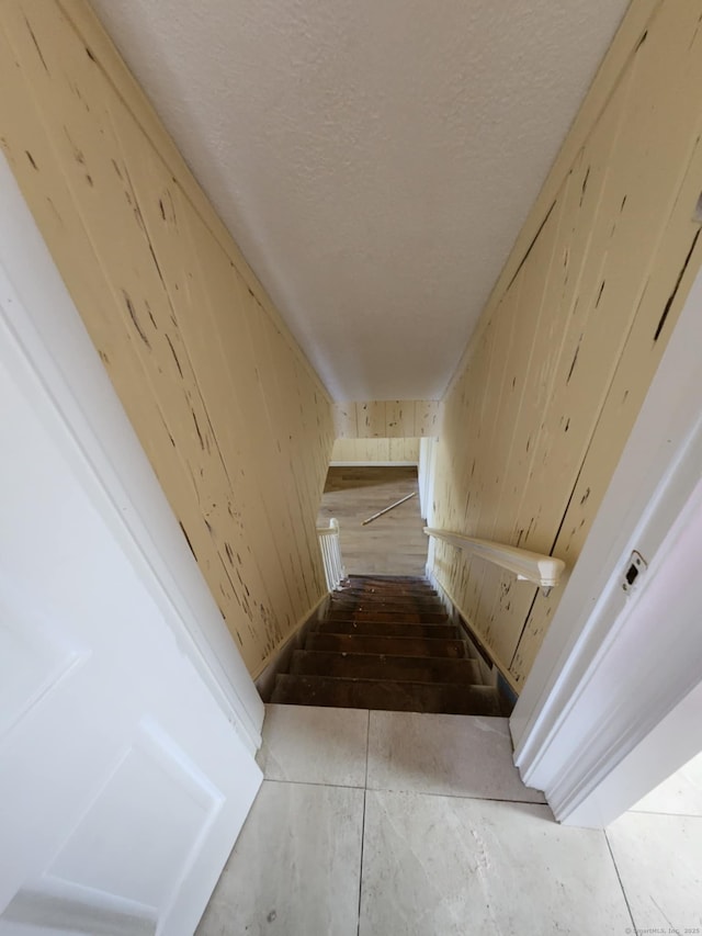 20 Rosina Rd, Hamden, CT 06514 - staircase featuring wooden walls and a textured ceiling