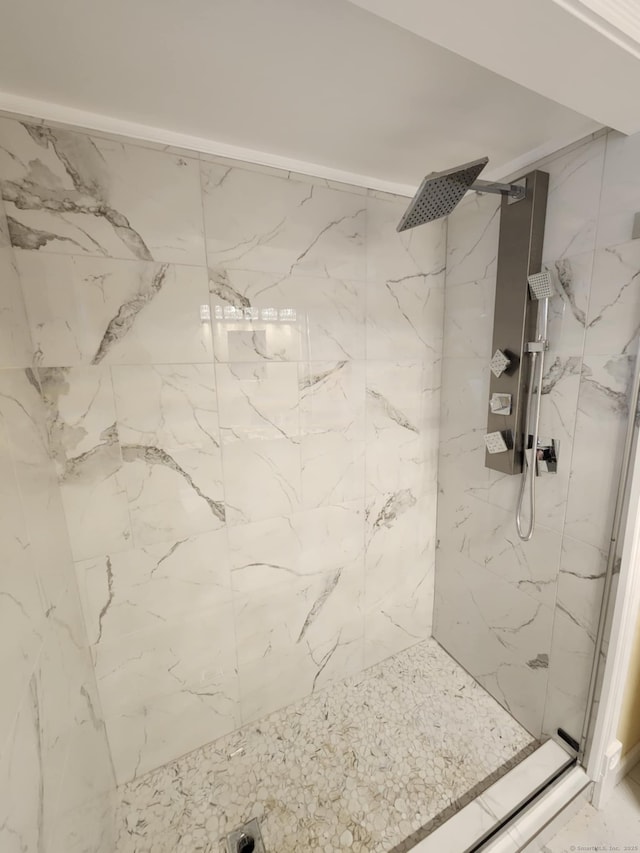 full bath featuring a marble finish shower