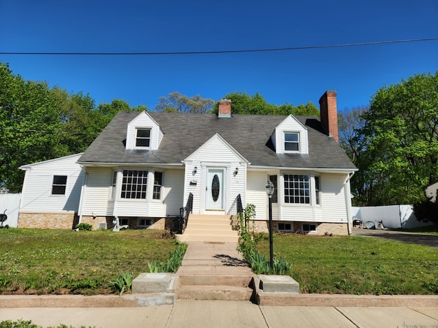 cape cod house with a chimney and a front lawn