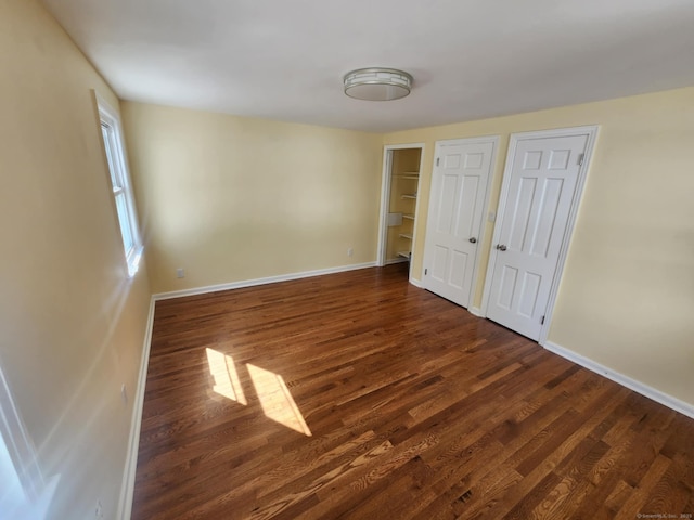 20 Rosina Rd, Hamden, CT 06514 - unfurnished bedroom with dark wood-style floors and two closets