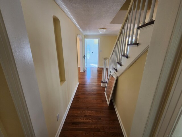 20 Rosina Rd, Hamden, CT 06514 - hallway featuring dark wood-style flooring, a textured ceiling, ornamental molding, arched walkways, and stairway