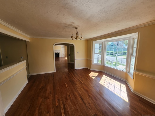 20 Rosina Rd, Hamden, CT 06514 - unfurnished dining area with arched walkways, a textured ceiling, dark wood finished floors, a chandelier, and crown molding