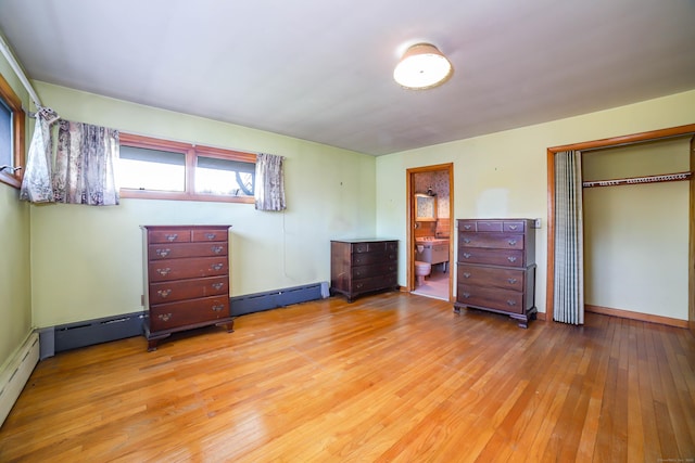 bedroom featuring ensuite bath, a closet, and hardwood / wood-style floors
