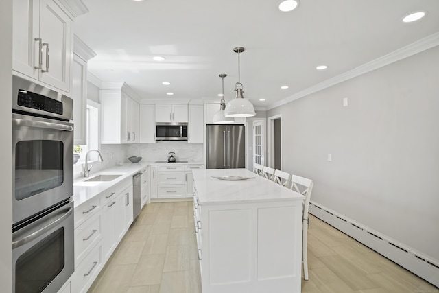kitchen featuring a kitchen island, decorative backsplash, stainless steel appliances, a baseboard radiator, and a sink