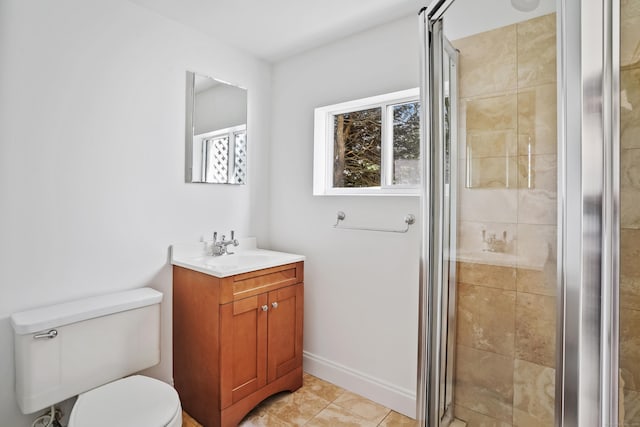 bathroom featuring toilet, vanity, and a stall shower