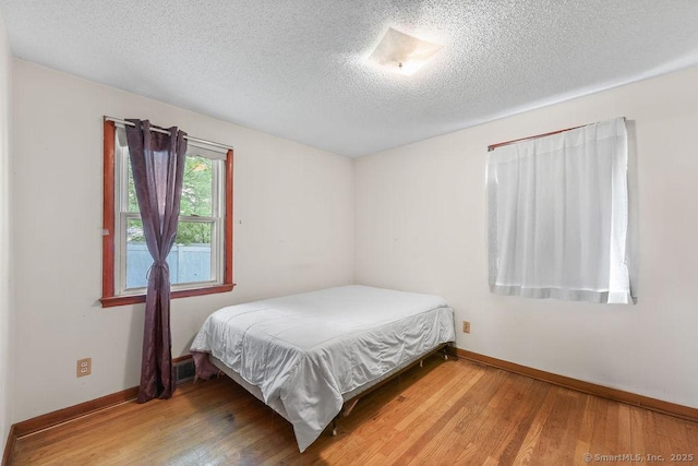 287 Prospect St, Wethersfield, CT 06109 - bedroom featuring a textured ceiling, wood finished floors, and baseboards