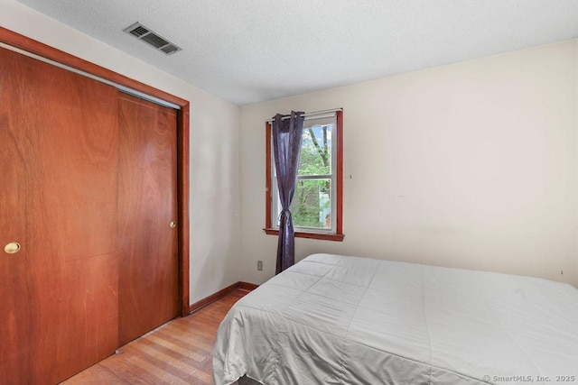 287 Prospect St, Wethersfield, CT 06109 - bedroom featuring wood finished floors, a closet, baseboards, and a textured ceiling