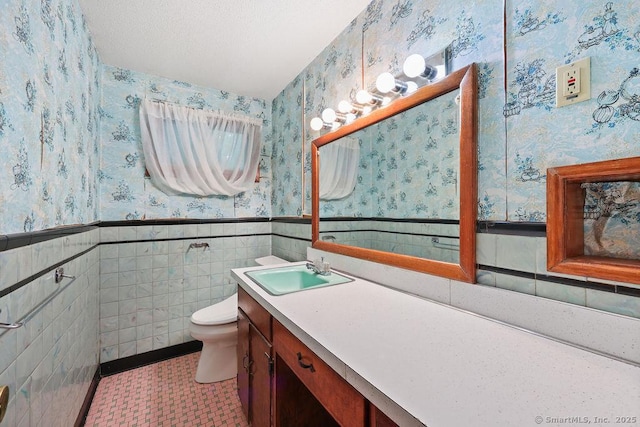 287 Prospect St, Wethersfield, CT 06109 - bathroom with wallpapered walls, wainscoting, toilet, and vanity