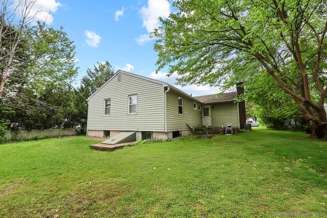 287 Prospect St, Wethersfield, CT 06109 - view of home's exterior with a chimney and a yard