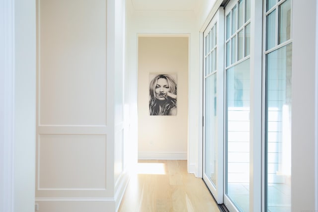 hall with wood finished floors and baseboards