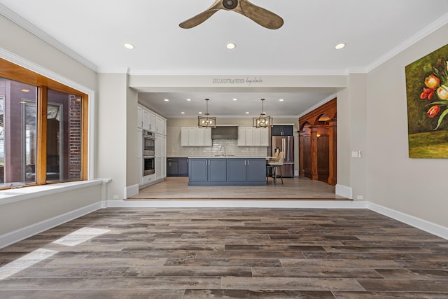 14 Turnberry Rd, Wallingford, CT 06492 - unfurnished living room featuring light wood-style flooring, a ceiling fan, recessed lighting, baseboards, and ornamental molding