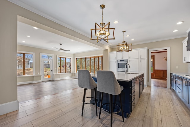 14 Turnberry Rd, Wallingford, CT 06492 - kitchen with a sink, light countertops, stainless steel oven, a chandelier, and ornamental molding