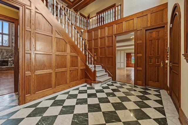 14 Turnberry Rd, Wallingford, CT 06492 - misc room with stairway, a towering ceiling, and wooden walls