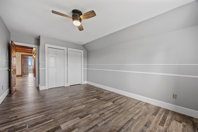 14 Turnberry Rd, Wallingford, CT 06492 - unfurnished bedroom with multiple closets, baseboards, dark wood-style flooring, ceiling fan, and vaulted ceiling