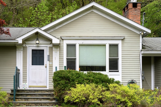128 S Kent Rd, Kent, CT 06785 - view of front facade featuring a chimney and roof with shingles
