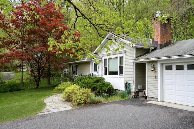 128 S Kent Rd, Kent, CT 06785 - view of side of property with a yard, driveway, a chimney, and a garage